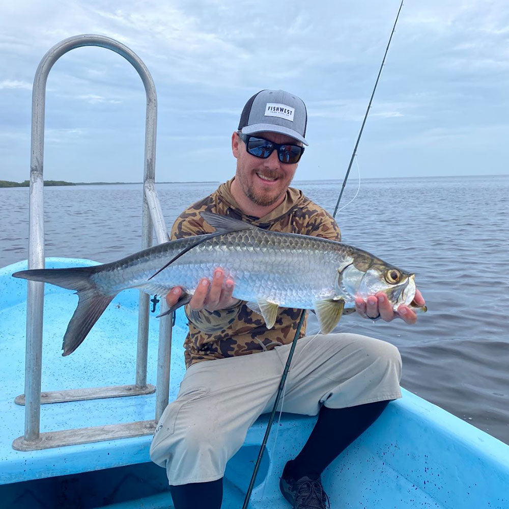 JC enjoying the flats of Mexico's Yucatan Peninsula with a nice baby Tarpon. 