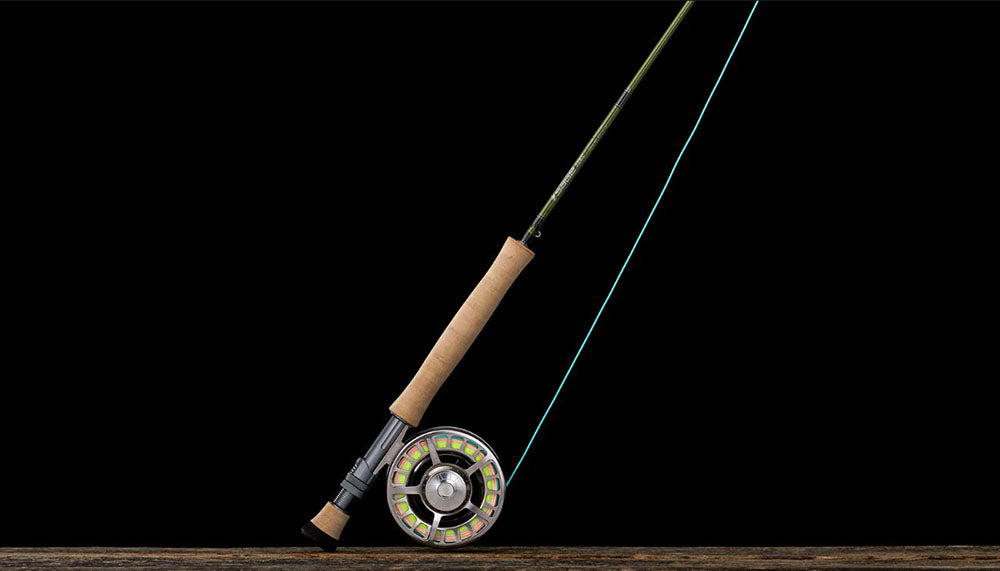 A Sage Sonic Fly Rod with reel on a dark background