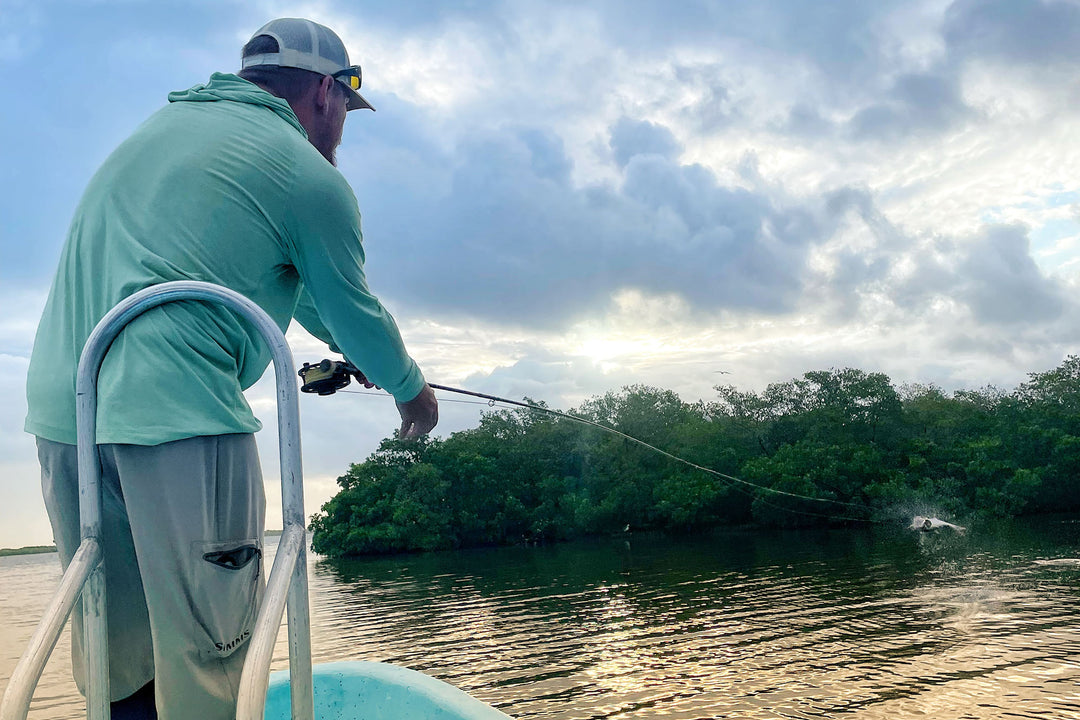 Fishwest GM, JC watching as a Tarpon puts on an aerial show on the flats near the Tarpon Cay Lodge.