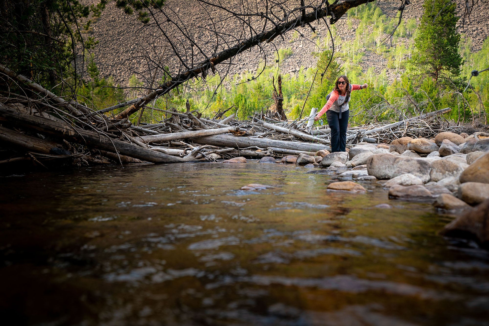 An angler fly fishing a small creek in Utah's Uinta National Forest.