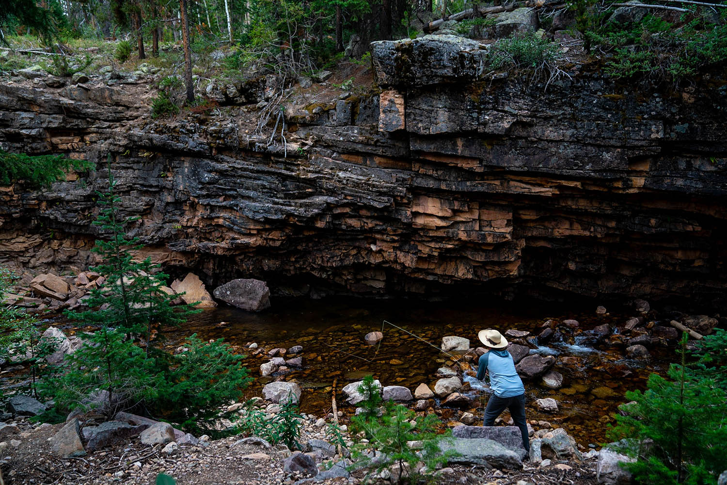 An angler fishing Utah's picturesque Upper Provo River in the Uinta National Forest. 