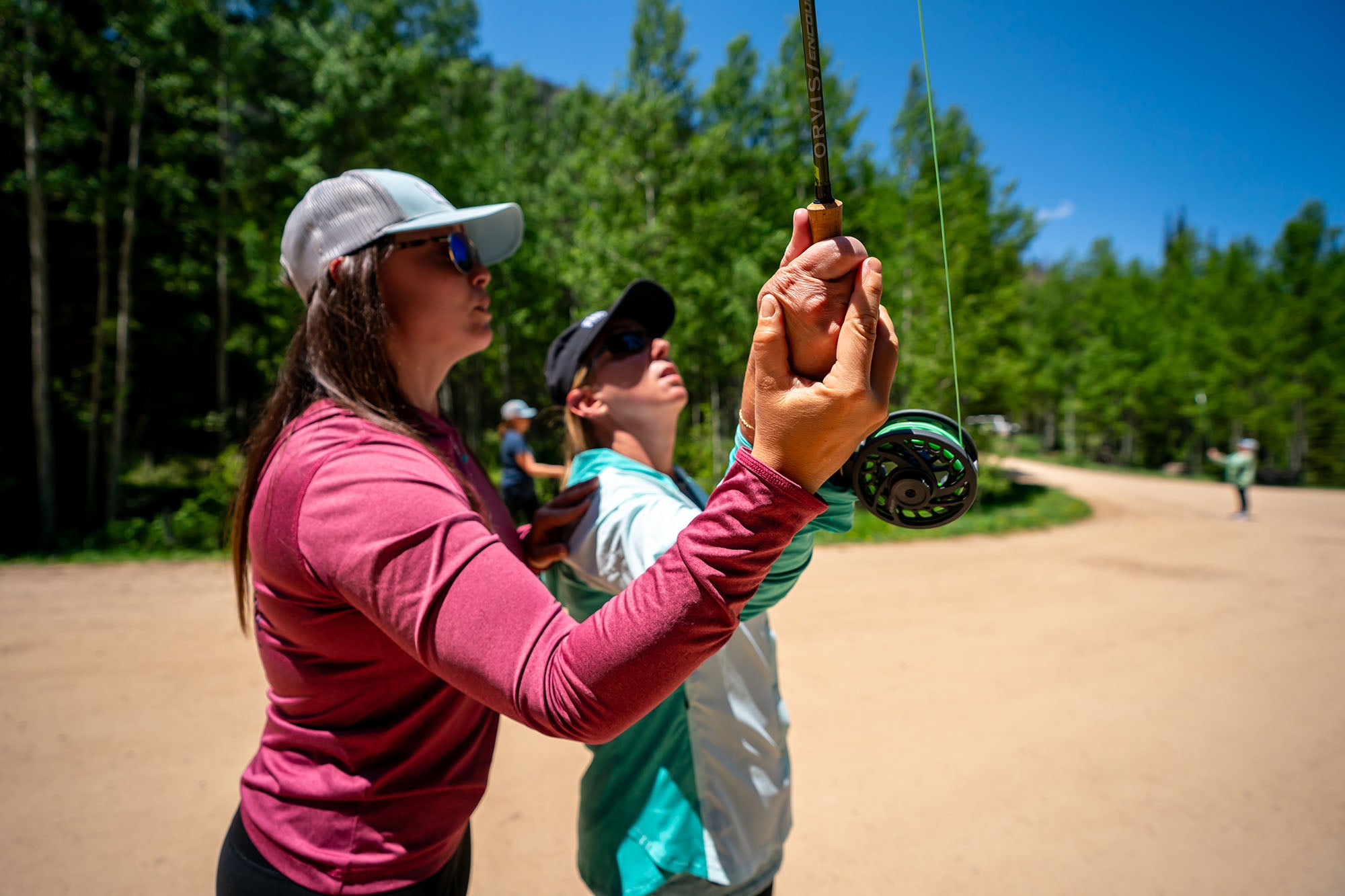 Fishwest Guide & Shop Manager Brooke Bailey giving instruction on how to cast a fly rod in the Uinta Mountains.